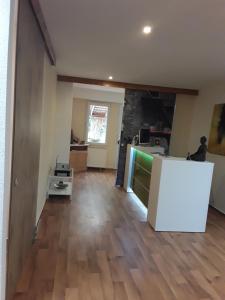 a kitchen and a living room with a wooden floor at Lee ZEN in Leezen +7 photos