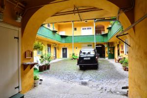 a car parked in the courtyard of a building at FLH - Best Location for Good Vibes - City Center in Sibiu
