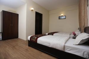 Postelja oz. postelje v sobi nastanitve Hotel Hema