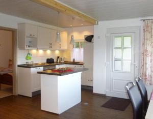 a kitchen with white cabinets and a counter top at Rabennest in Rüthen