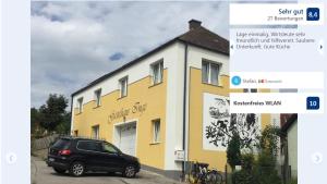 samochód zaparkowany przed żółto-białym budynkiem w obiekcie Braunegger-Hof Gasthof Mayer w mieście Braunegg