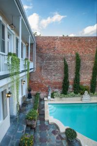 a swimming pool in front of a brick building at Chateau Hotel in New Orleans