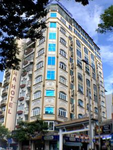 a tall building with windows on the side of it at Saigonciti Hotel A in Ho Chi Minh City