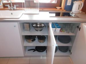 a kitchen counter with a sink and some dishes at Domki letniskowe U Joli - Jolanta Potrykus in Władysławowo +10 photos
