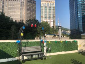 a park with a bench and a roller coaster at K-POP Hotel Seoul Station in Seoul