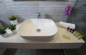 a white sink on a counter in a bathroom at Filoxenia Hotel in Volos