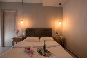 a bedroom with a bed with a pink bow on it at Filoxenia Hotel in Volos