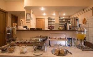 a kitchen with a counter with some food on it at Filoxenia Hotel in Volos