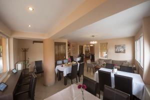 a dining room with a table and chairs at Filoxenia Hotel in Volos