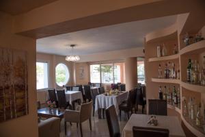 a dining room with tables and chairs in a restaurant at Filoxenia Hotel in Volos