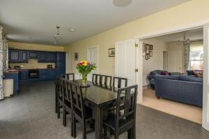 a dining room and living room with a table and chairs at 20 village square Glaslough in Glaslough