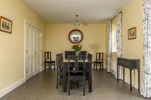 a dining room with a table and chairs and a mirror at 20 village square Glaslough in Glaslough