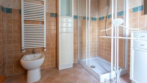 a bathroom with a toilet and a shower at La casa della Cindy in Dervio +37 photos