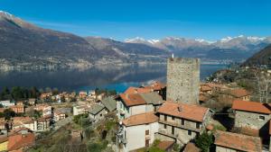 a town on the shore of a lake with mountains at La casa della Cindy in Dervio