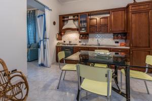 a kitchen with wooden cabinets and a table and chairs at Taste of Naples with terrace in Naples