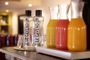 three bottles of juice sitting on a table at Le Cavendish in Cannes