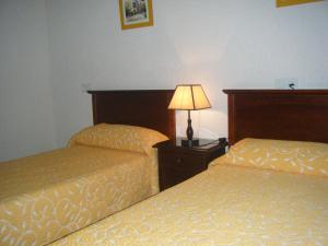 Posteľ alebo postele v izbe v ubytovaní Hostal Muriel
