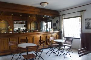 a room with a bar with chairs and a table at Art Hotel Panorama in Pyrgadikia