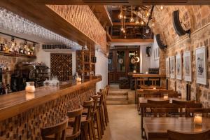 
a restaurant with tables and chairs in it at 10GR Hotel & Wine Bar Rhodes in Rhodes Town
