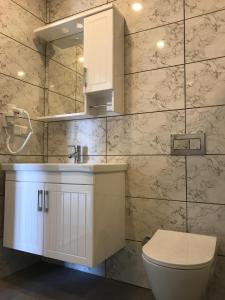 a bathroom with a white sink and a toilet at Ada Adrasan Hotel in Adrasan