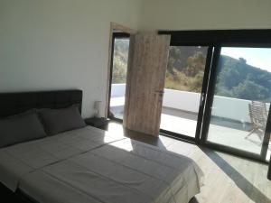 Ένα ή περισσότερα κρεβάτια σε δωμάτιο στο Sea Breeze Ecological Villa