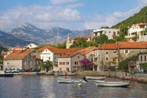 a group of boats in the water near a town at House by The Sea in Tivat