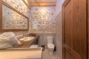 a bathroom with a sink and a toilet and a mirror at Ismini Kaminaki Beach in Nisakion +9 photos