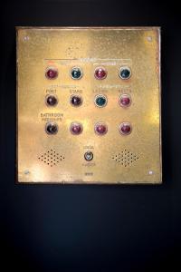 a metal panel with buttons on a black background at Hotel Albert Plage in Knokke-Heist