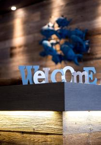 
a blue and white sign on a wooden table at Hotel Albert Plage in Knokke-Heist
