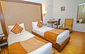A bed or beds in a room at Hotel Clarks Collection Bhavnagar