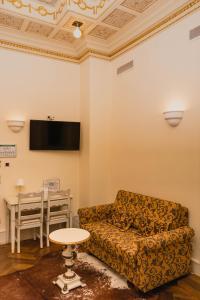 a living room with a couch and a table at Hotel Villa Marstall in Heidelberg