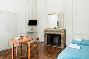 a room with a table and a bed and a mirror at Patios de Recoleta in Buenos Aires