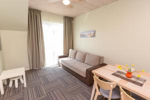 a living room with a couch and a table at Vila Paula in Palanga