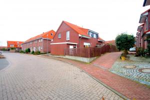 a cobblestone street in a residential neighborhood with houses at Private Rooms in Hannover