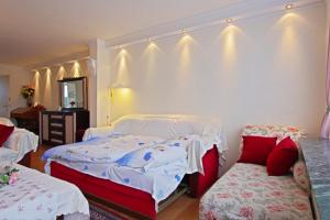 a bedroom with two beds and a table and a mirror at Private Apartment in Hannover