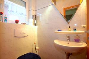 a bathroom with a sink and a mirror at Private Rooms in Hannover