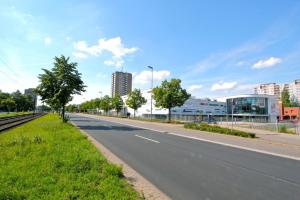 an empty street in a city with tall buildings at Private Rooms Laatzen in Hannover