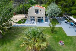 an aerial view of a house with a swimming pool at Tiamo Secrets - Palm Garden in Vourvourou