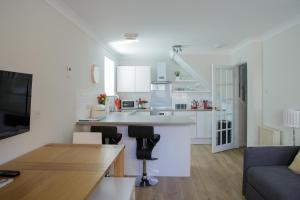 a kitchen and living room with a couch and a table at The Haven in Dunbar