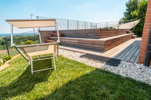 a chair sitting on the grass in a yard at Agriturismo Dai Gobbi in Fara Vicentino