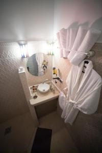 a bathroom with a toilet and a sink and a mirror at Bio Beldi HOME in Tafraout