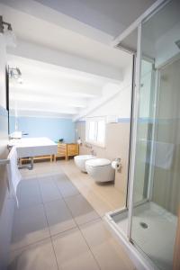 a bathroom with two sinks and a tub and a shower at Selenite in Capo dʼOrlando