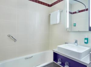a bathroom with a sink, toilet, and bathtub at Jurys Inn Exeter in Exeter