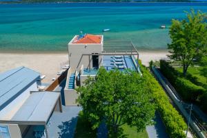 an aerial view of a house on the beach at Tiamo Secrets Beach Front by TravelPro - Vourvourou Halkidiki in Vourvourou +18 photos
