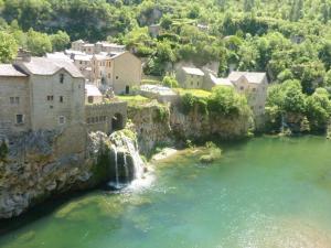 an aerial view of a river with a waterfall at Gite la maison de Jules in Sainte-Énimie
