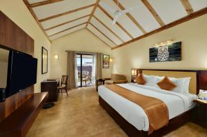 A bed or beds in a room at The Fern Sattva Resort - Polo Forest