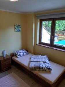 a small bed in a room with a window at Domki Beskid in Rzyki +88 photos