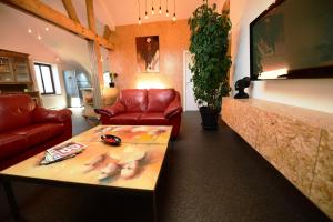 a living room with a couch and a coffee table at Le 42 in Durbuy