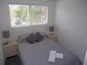 a bedroom with a bed with a white towel on it at River Sands Apartments in Maroochydore +46 photos