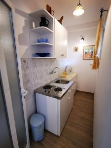 a small kitchen with a sink and a stove at Studio Marin in Dubrovnik
